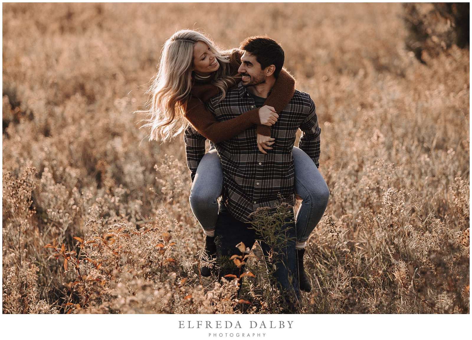 Funny piggyback in a field during engagement session