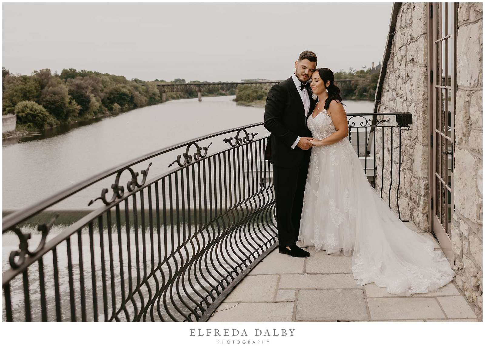 Bride and Groom on the Juliet Balcony overlooking the Grand River