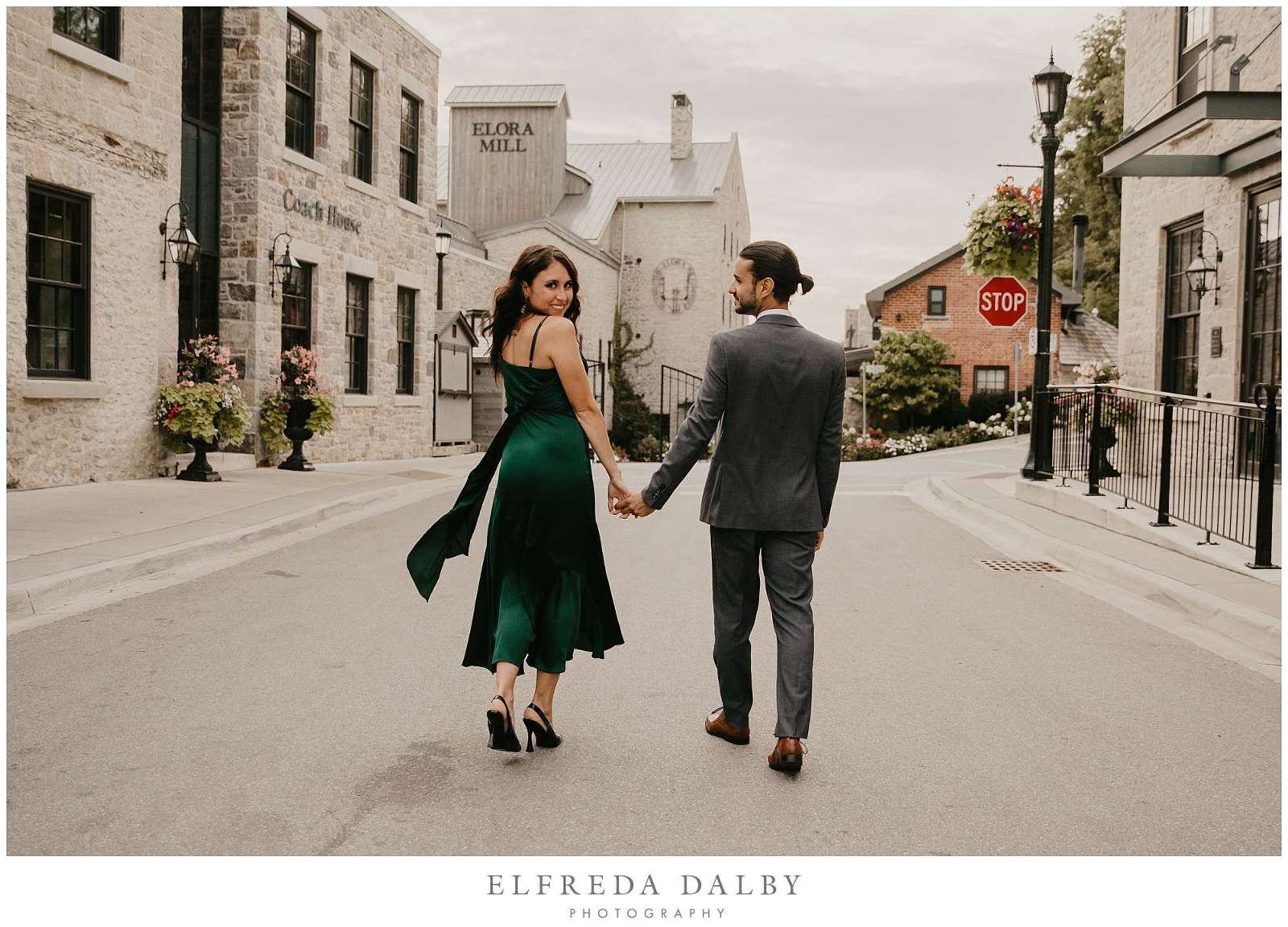 Beautiful couple walking down the street towards Elora Mill