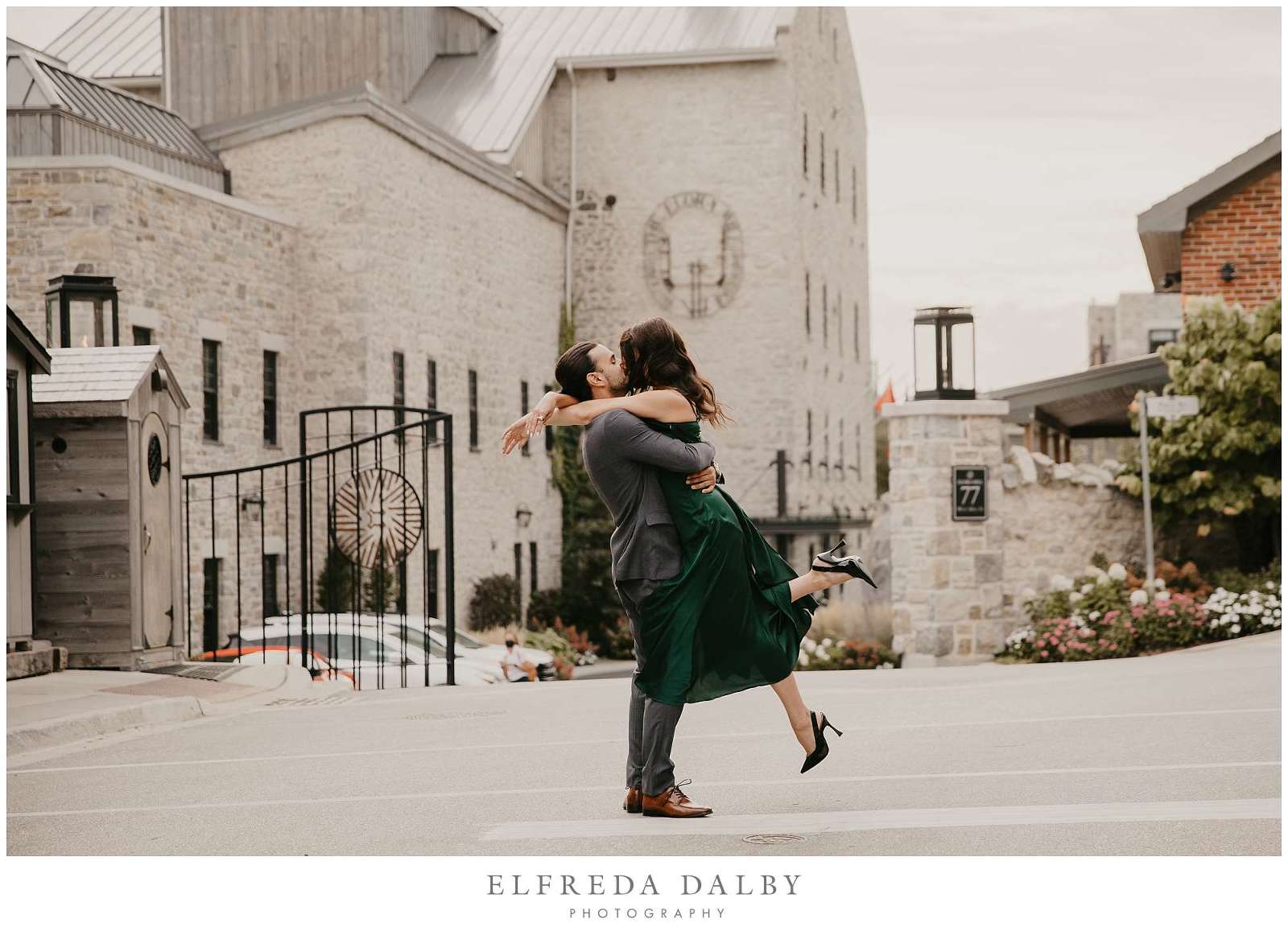 Guy picking up his fiancée in front of the Elora Mill