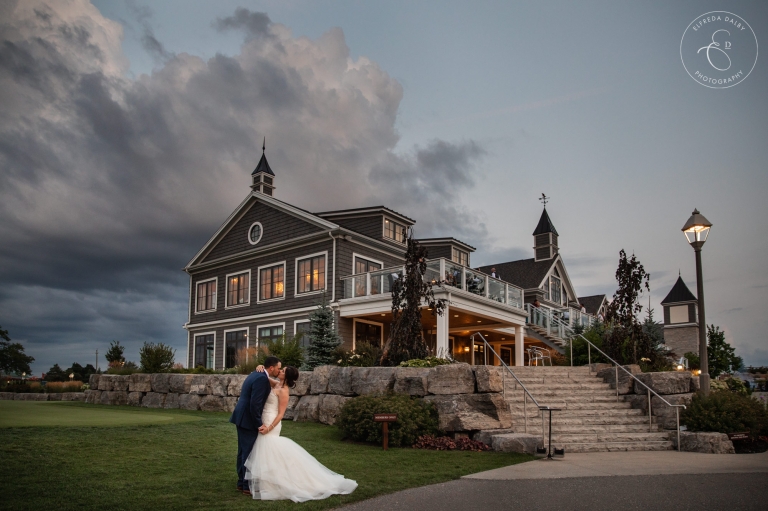 Couple sharing a kiss outside their Whistle Bear Golf Club wedding