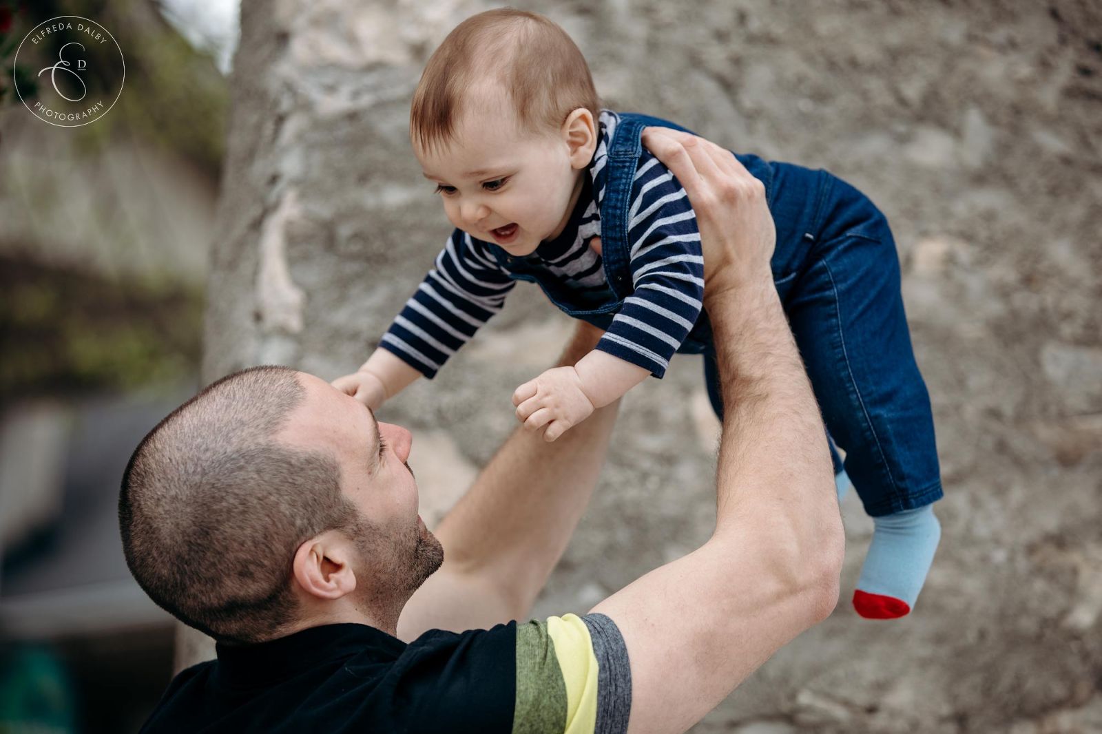Dad lifting his baby up