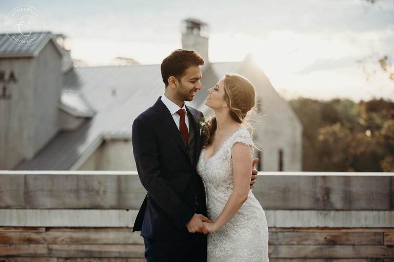 Bride and groom on the terrace of Elora Mill during sunset