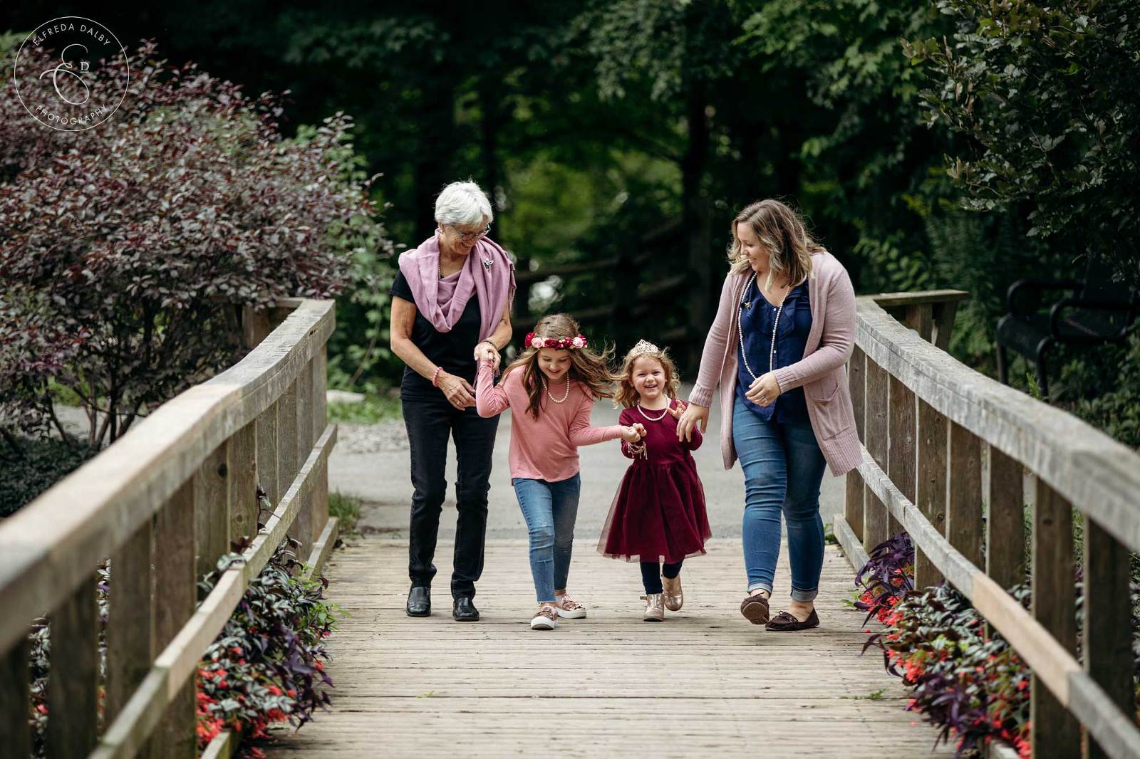 Little girls walking with their mom and grandmother