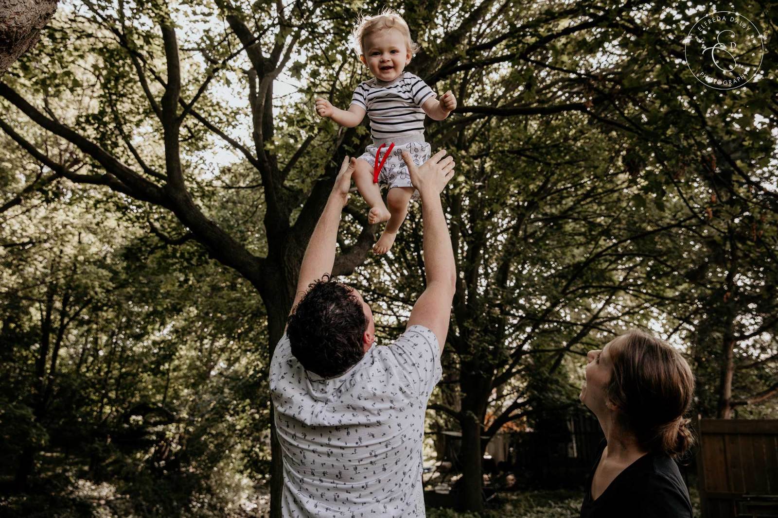 Dad toss baby in air and baby laughs