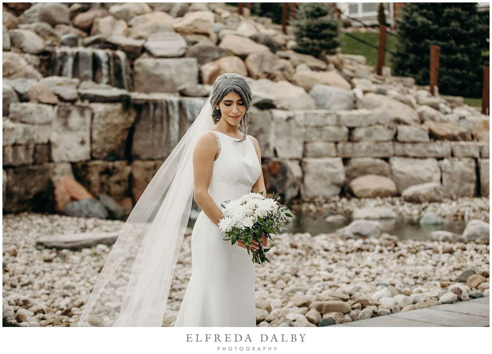 Beautiful bride in front of a waterfall