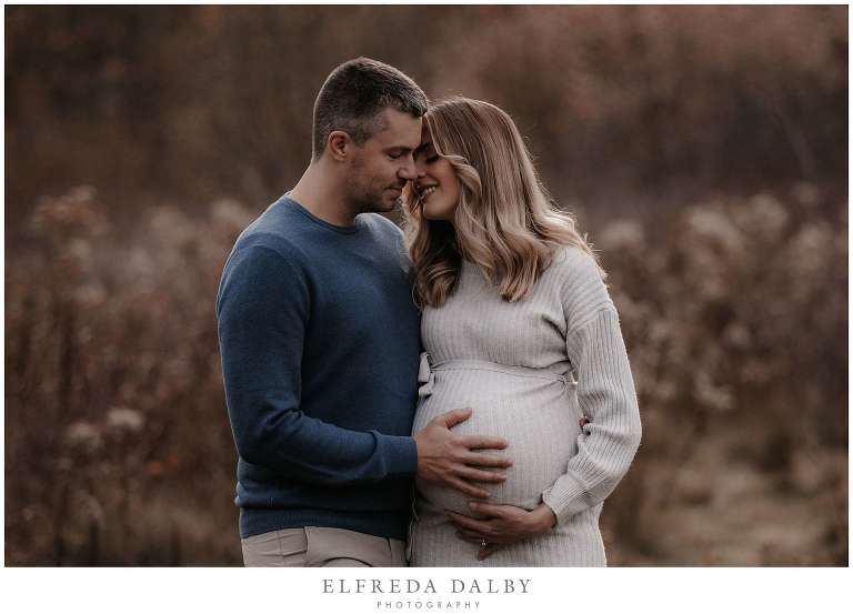 Beautiful couple during their maternity session in a field