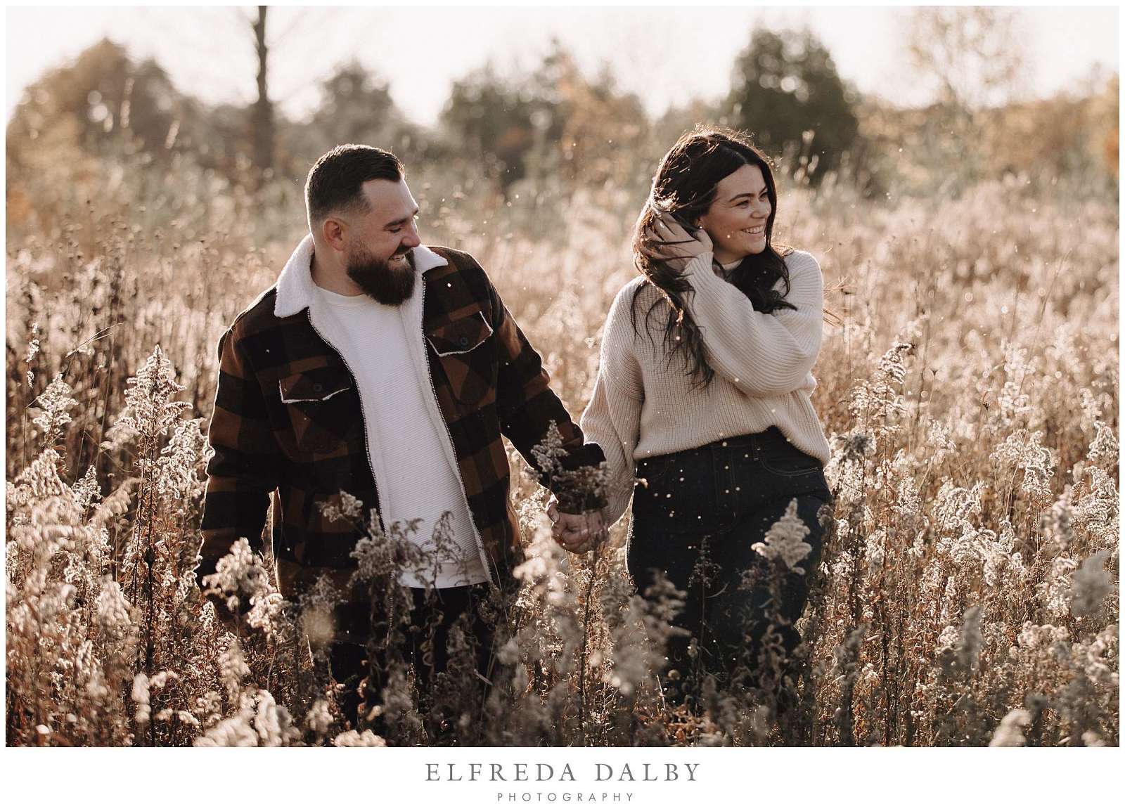 Fun couple walking through a field