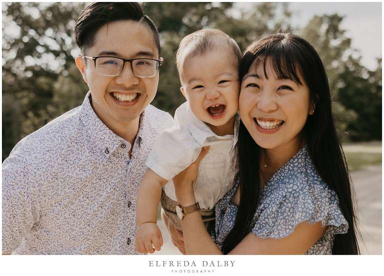 Cute baby boy laughing with his mom and dad