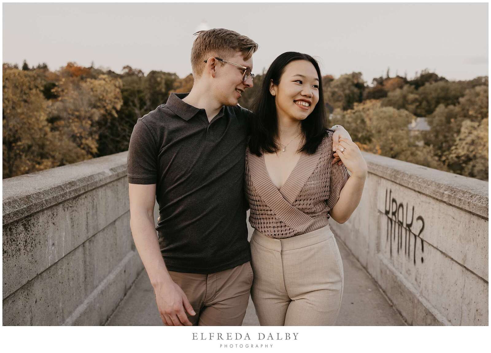 Couple walking together over a bridge in Guelph