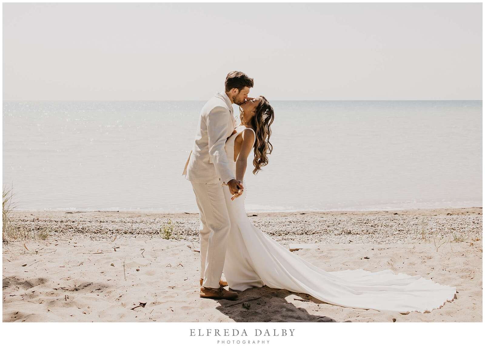 Bride and groom are kissing on Kincardine beach