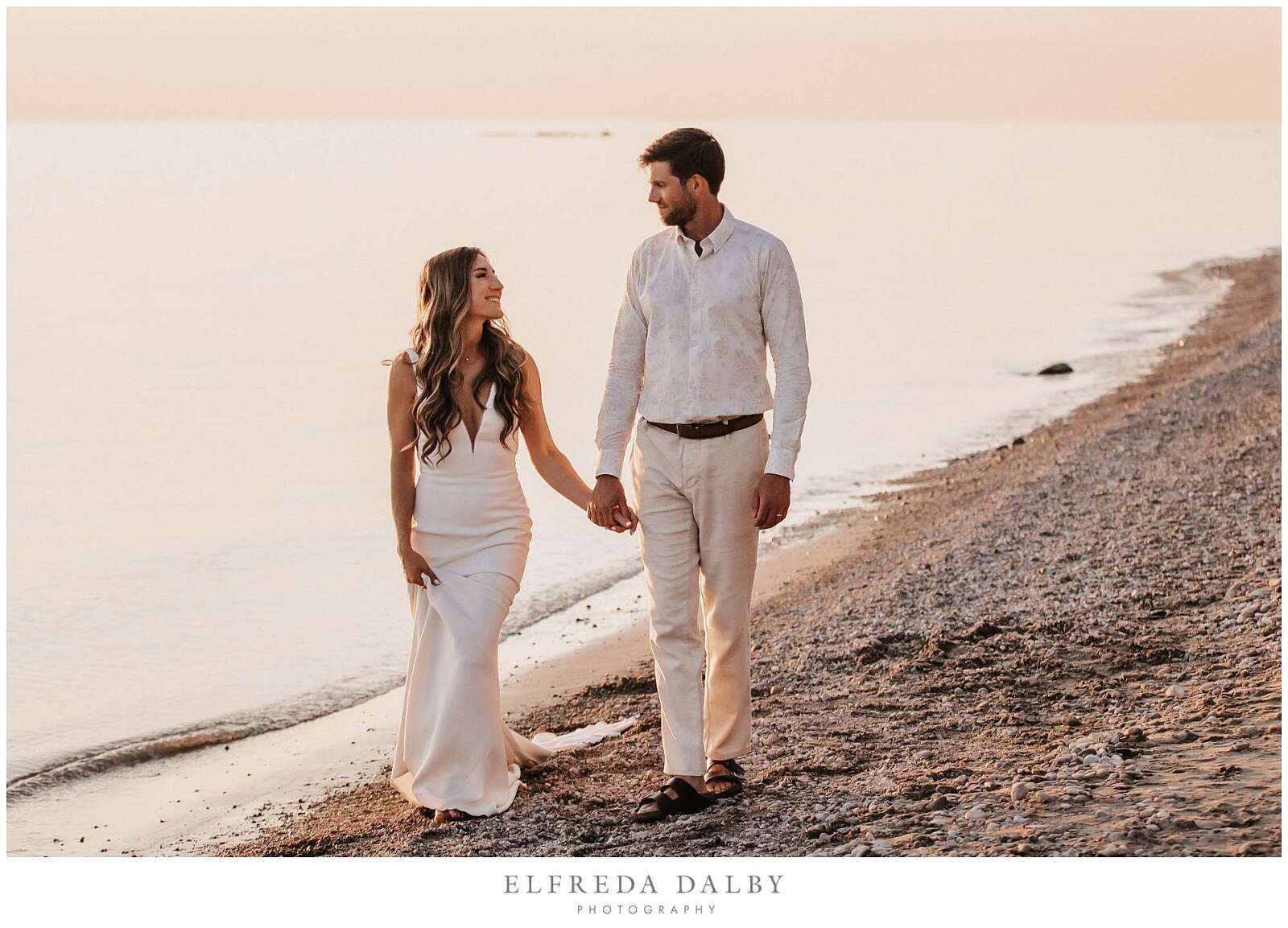 Married couple walking on Kincardine beach at sunset