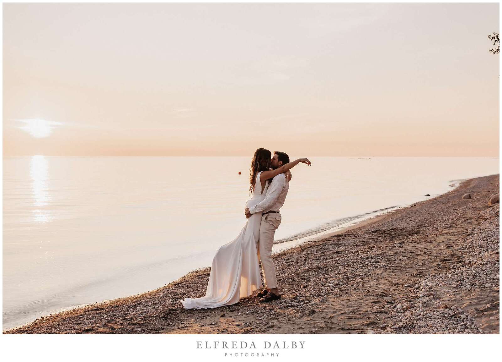 Romantic photo of a wedding couple on the beach at sunset