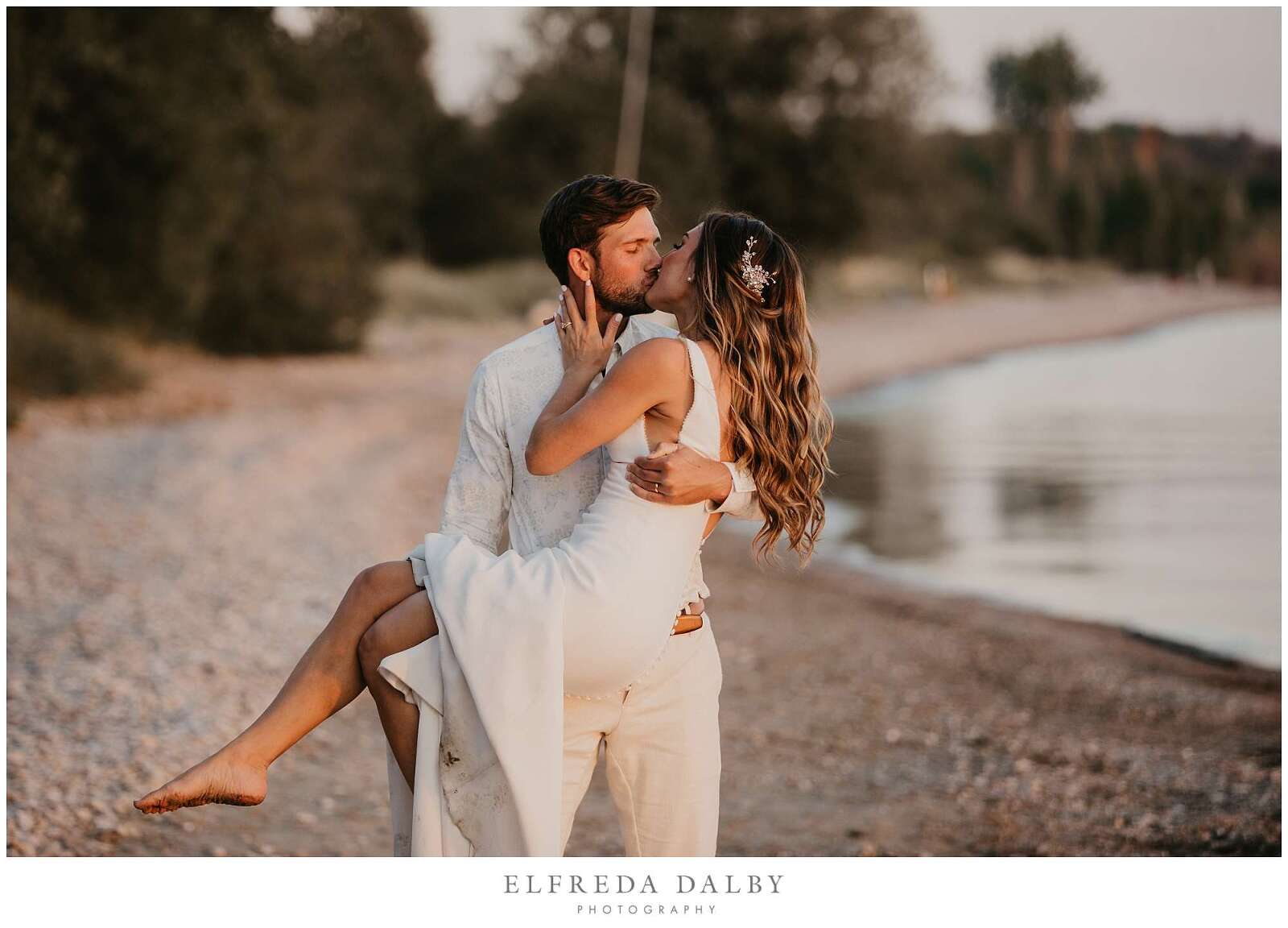 Groom holding his bride on Kincardine beach at sunset