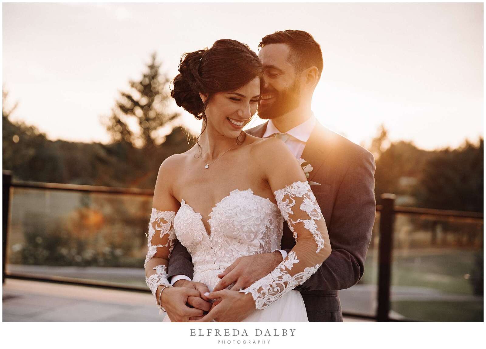 Groom holding his bride at Monthill Golf and Country Club at sunset