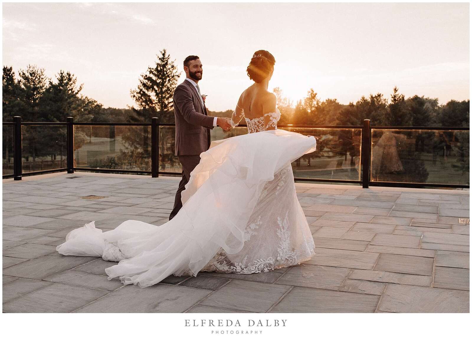 Bride and groom walking on the patio at Monthill Golf Club during sunset