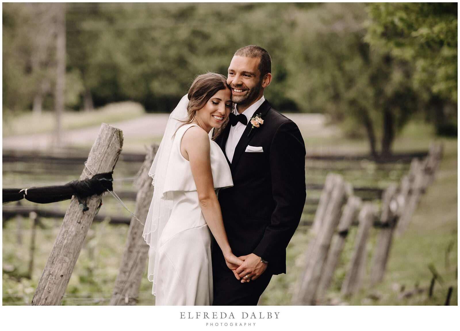 Bride and groom standing next to the vineyard at Hockley Valley Resort in Mono