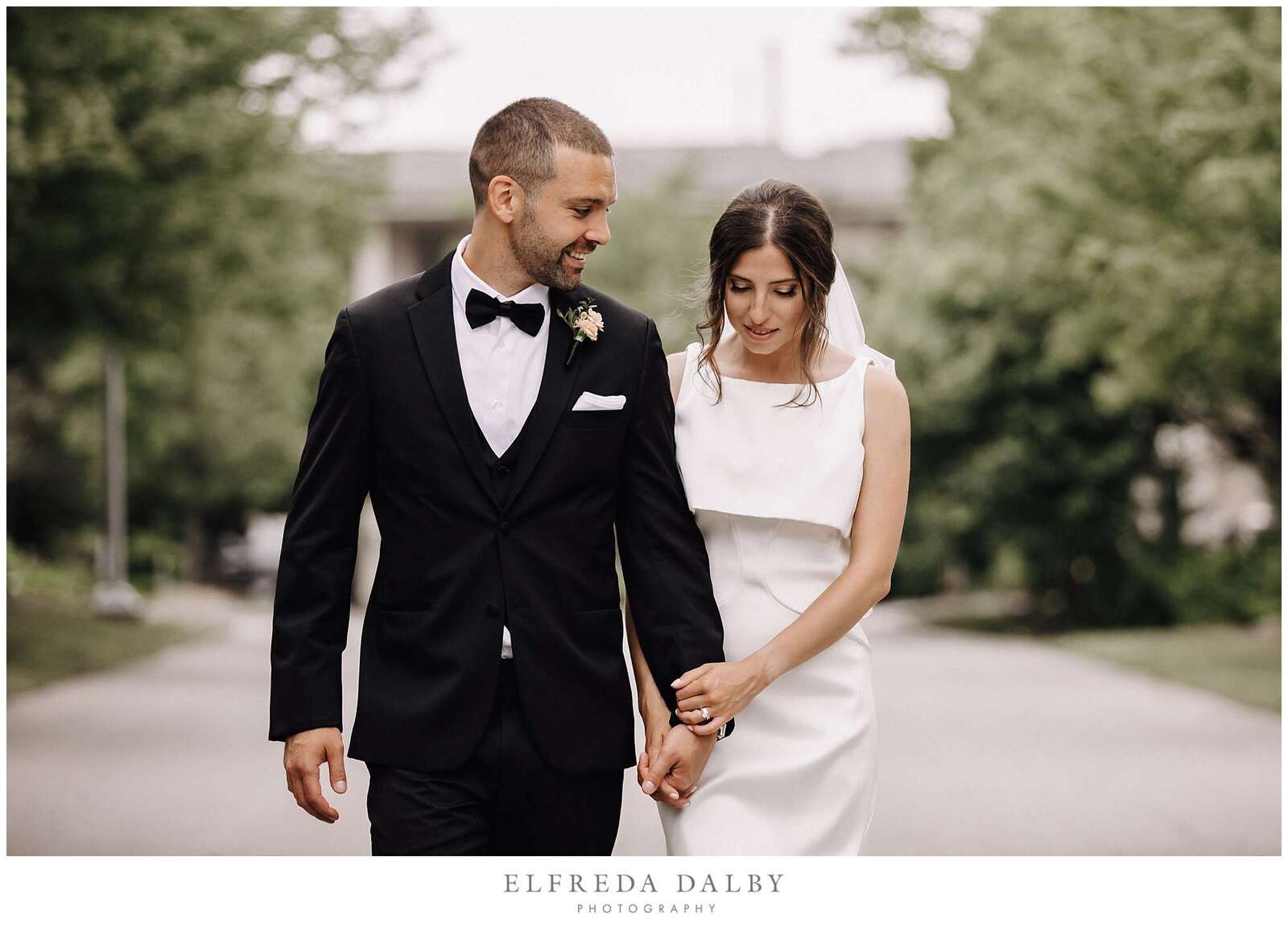 Bride and groom walking in the road in front of Hockley Valley Resort in Mono
