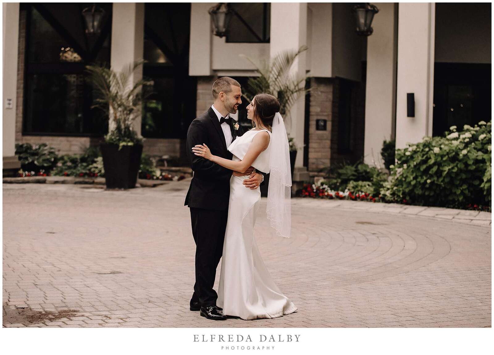 Bride and groom standing in front of Hockley Valley Resort in Mono