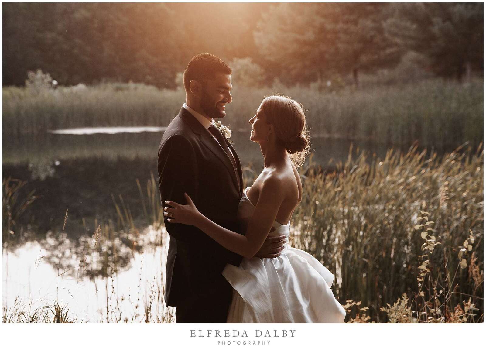 Bride and groom looking at each other during sunset
