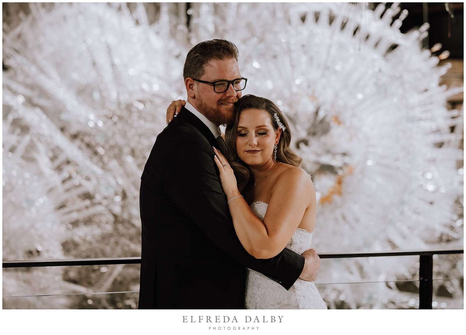 Bride and groom hugging each other inside the Tapestry Hall