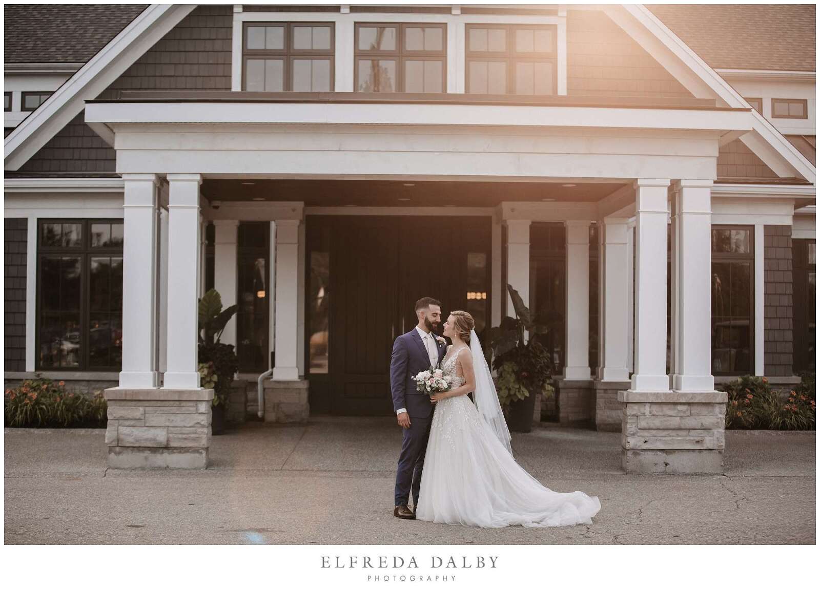 Bride and groom standing in front of Whistle Bear Golf Club