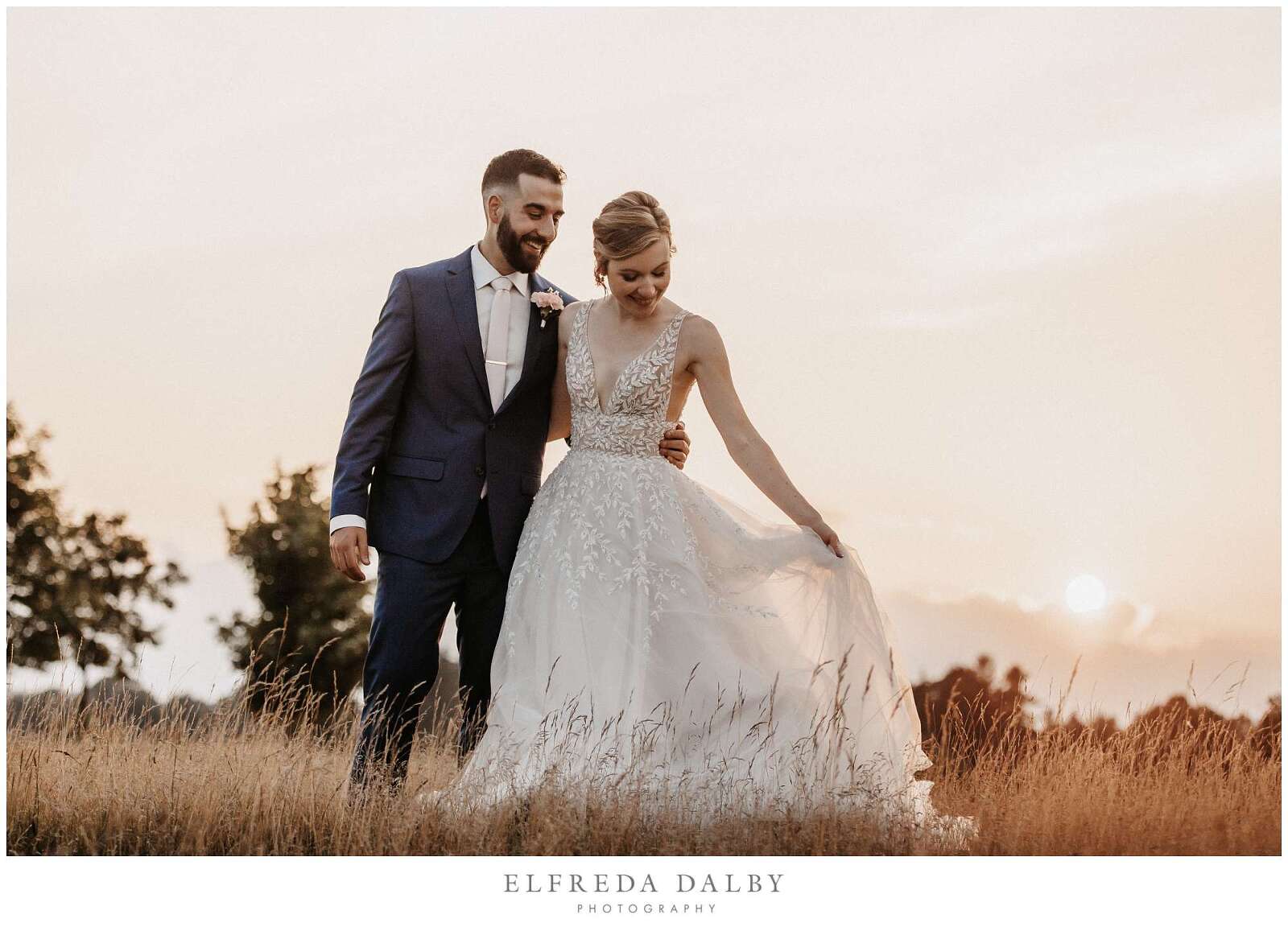 Bride and groom standing in a grassy field at Whistle Bear Golf Club