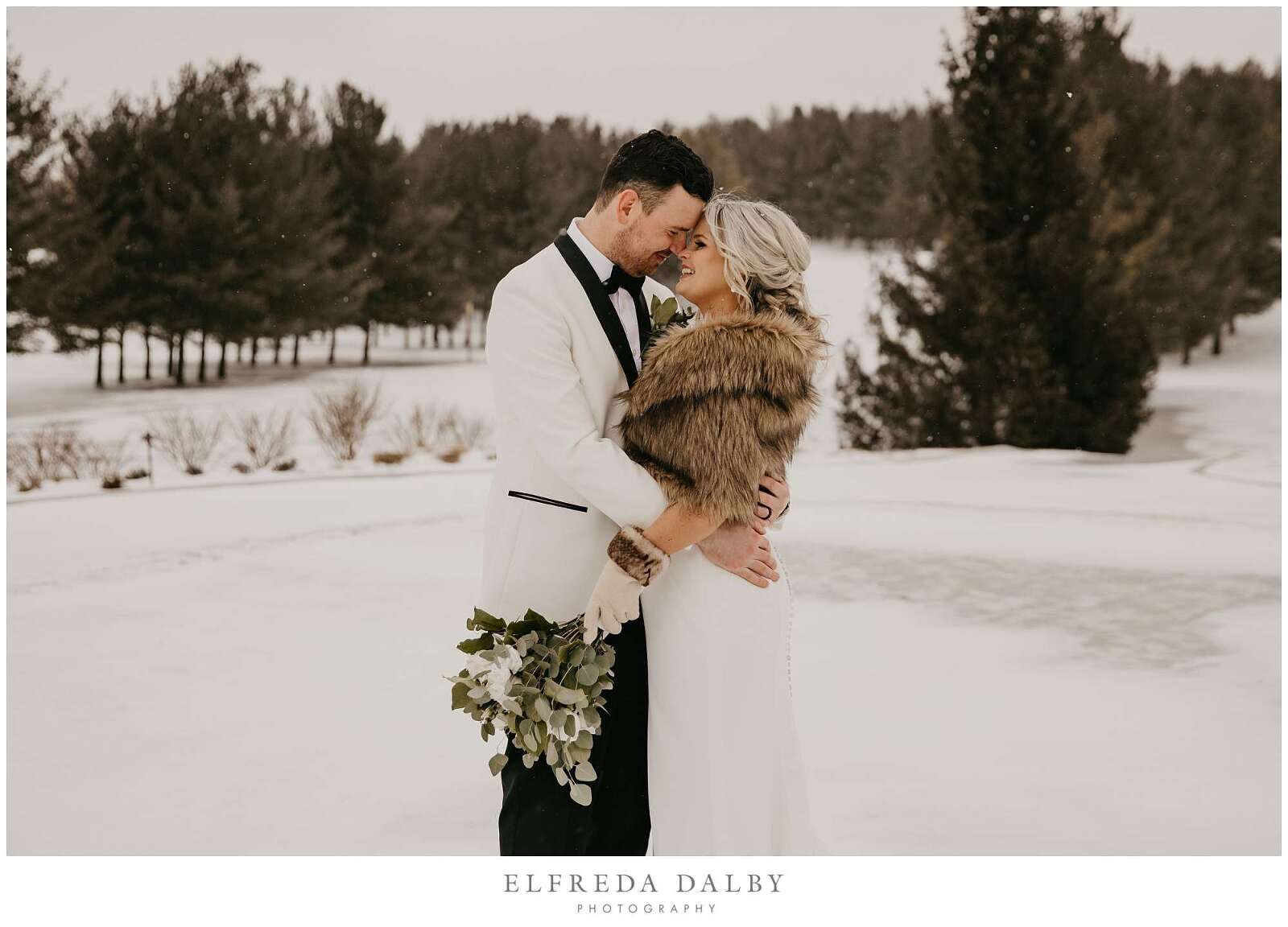 Bride and groom standing in the snow at MontHill Golf & Country Club