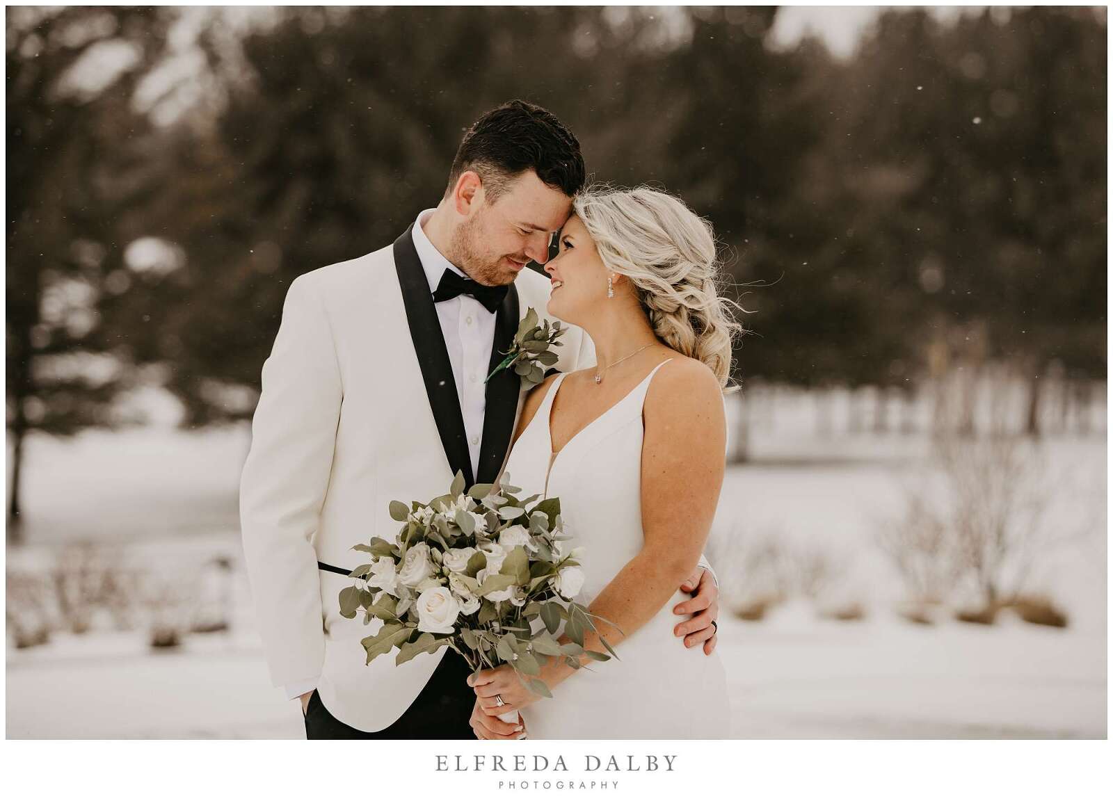 Bride and groom standing in the snow at MontHill Golf & Country Club