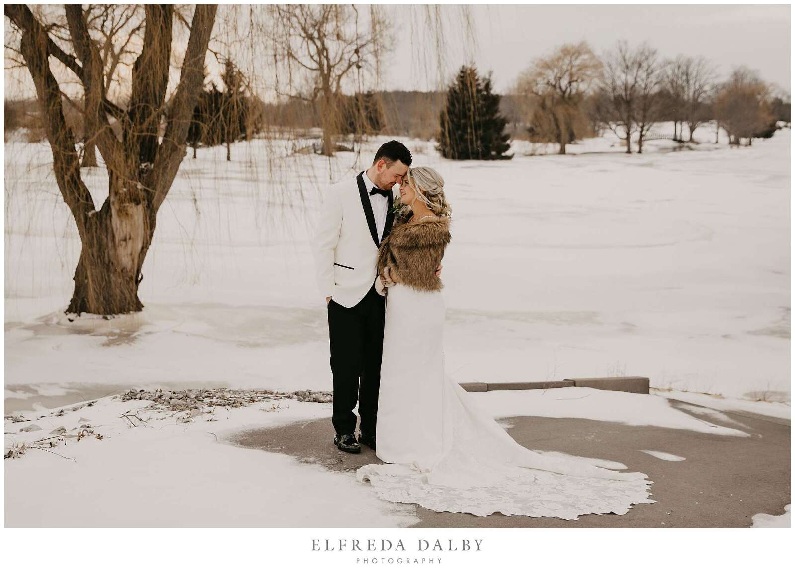 Bride and groom standing in the snow at MontHill Golf & Country Club