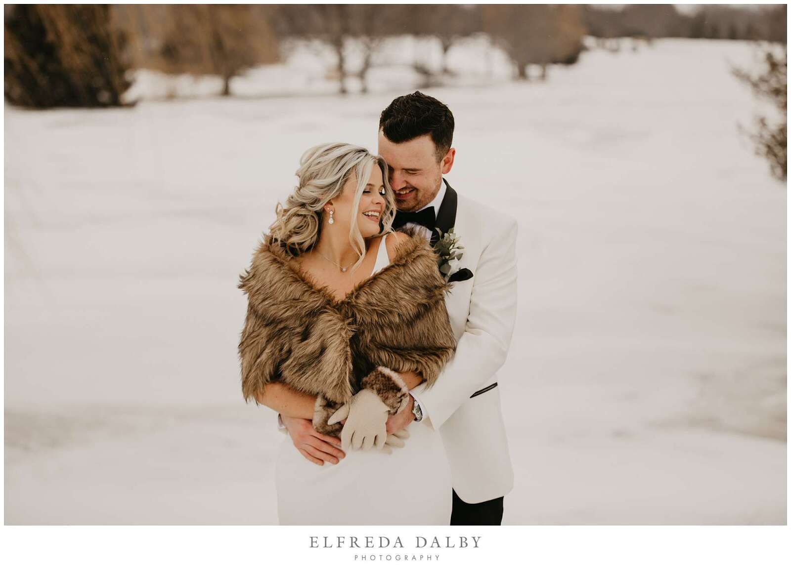 Bride and groom standing in the snow at MontHill Golf & Country Club