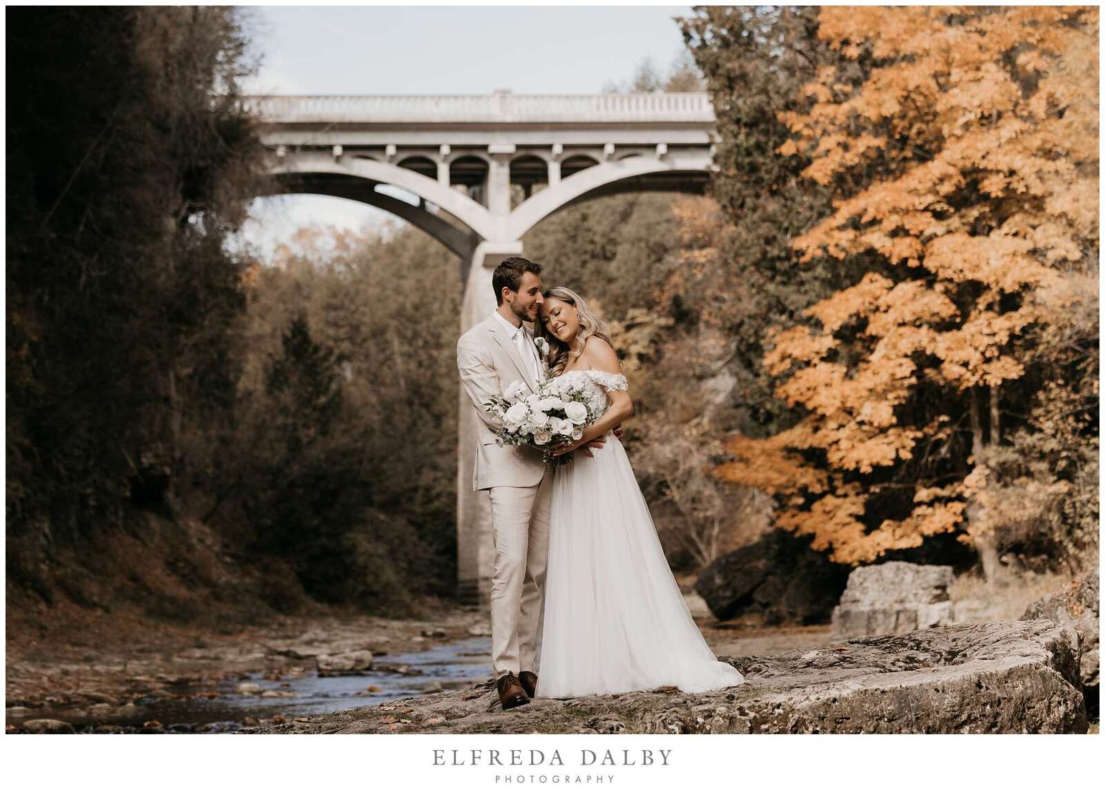 Bridge and groom standing on a rock in the Elora Gorge