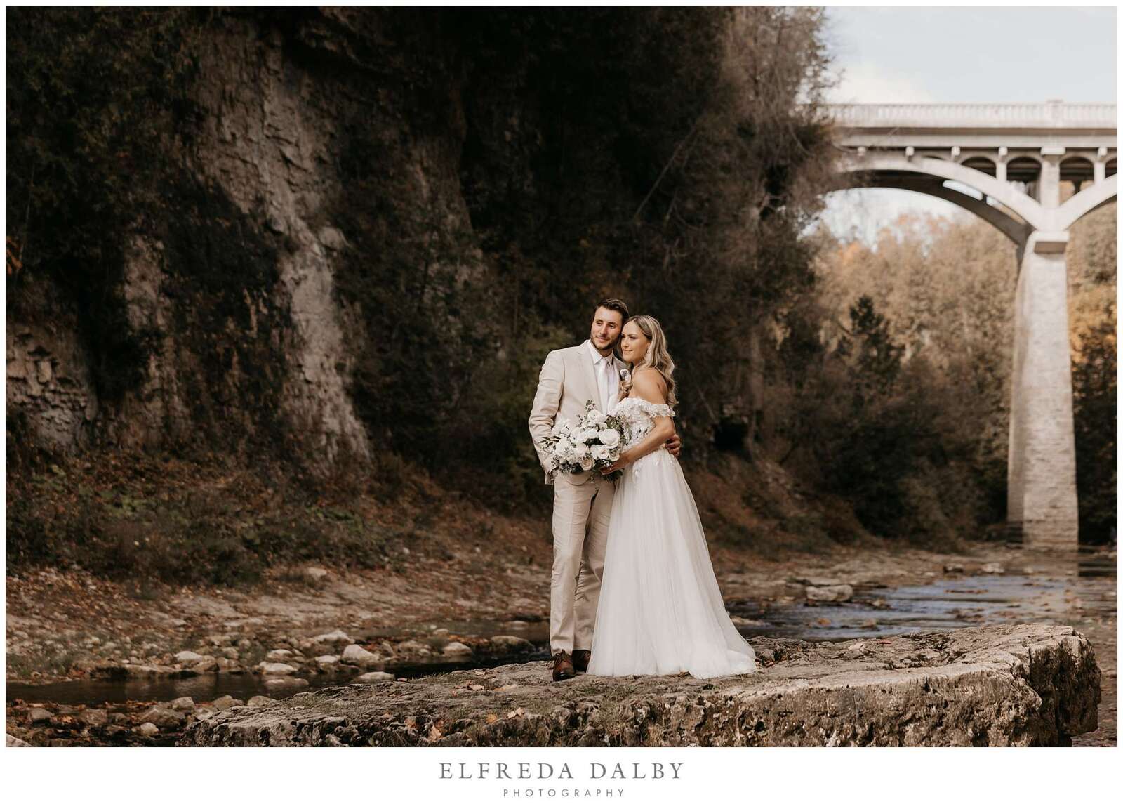 Bride and groom standing on a rock in the Elora Gorge