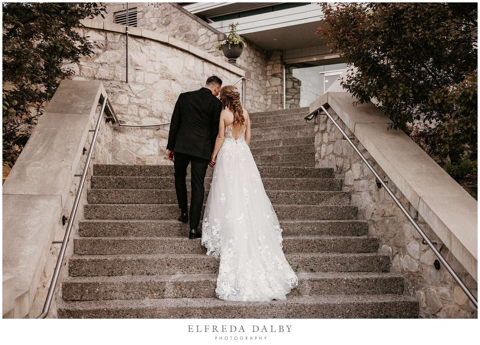 Bride and groom walking down the stairs at Cambridge Mill