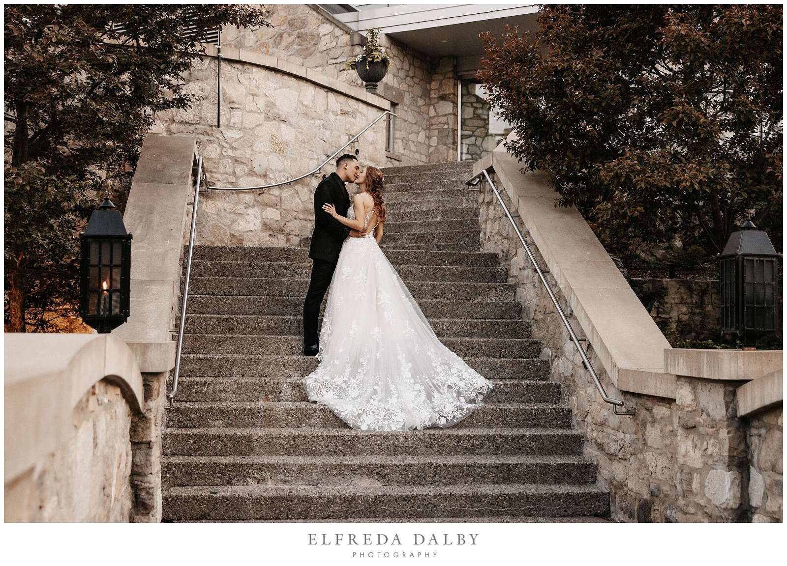 Bride and groom kissing on the stairs at Cambridge Mill