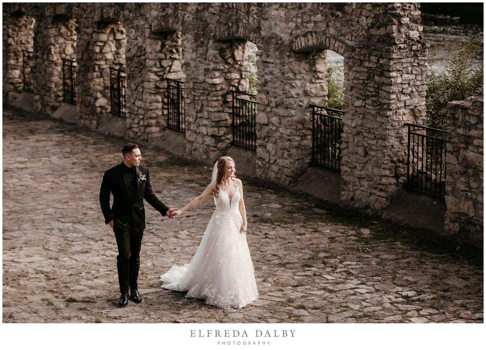 Bridge and groom walking at Mill Race Park at Cambridge Mill