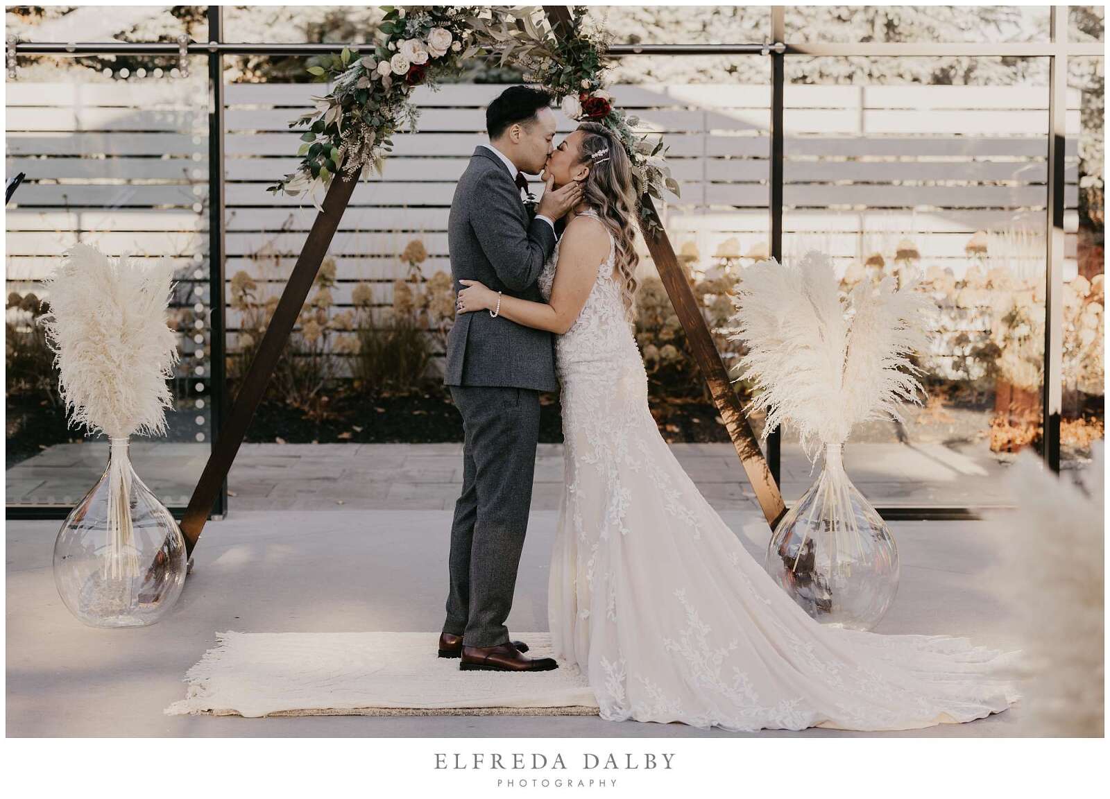 Bride and groom kissing in the chapel at Whistle Bear Golf Club