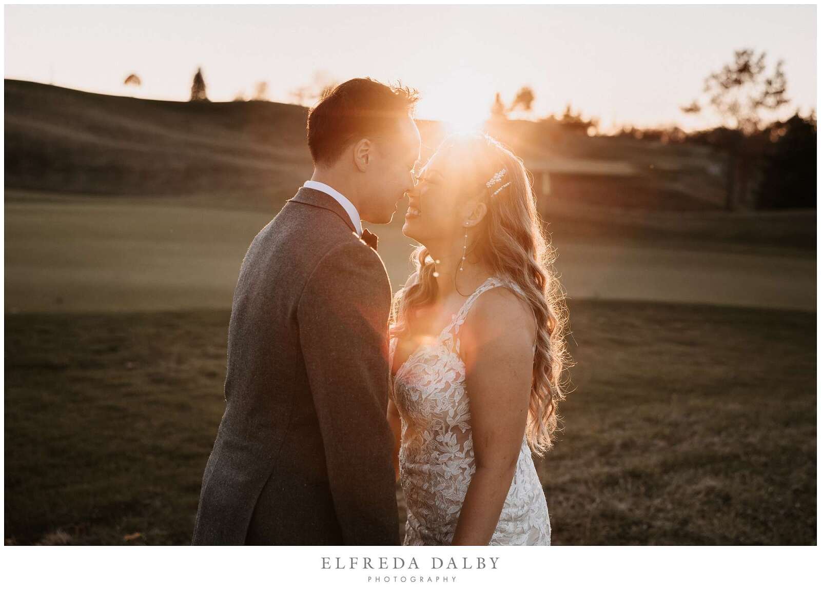 Bride and groom kissing during sunset at Whistle Bear Golf Club