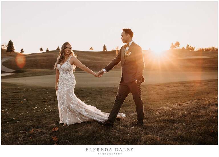 Bride and groom walking over the grass at Whistle Bear Golf Club