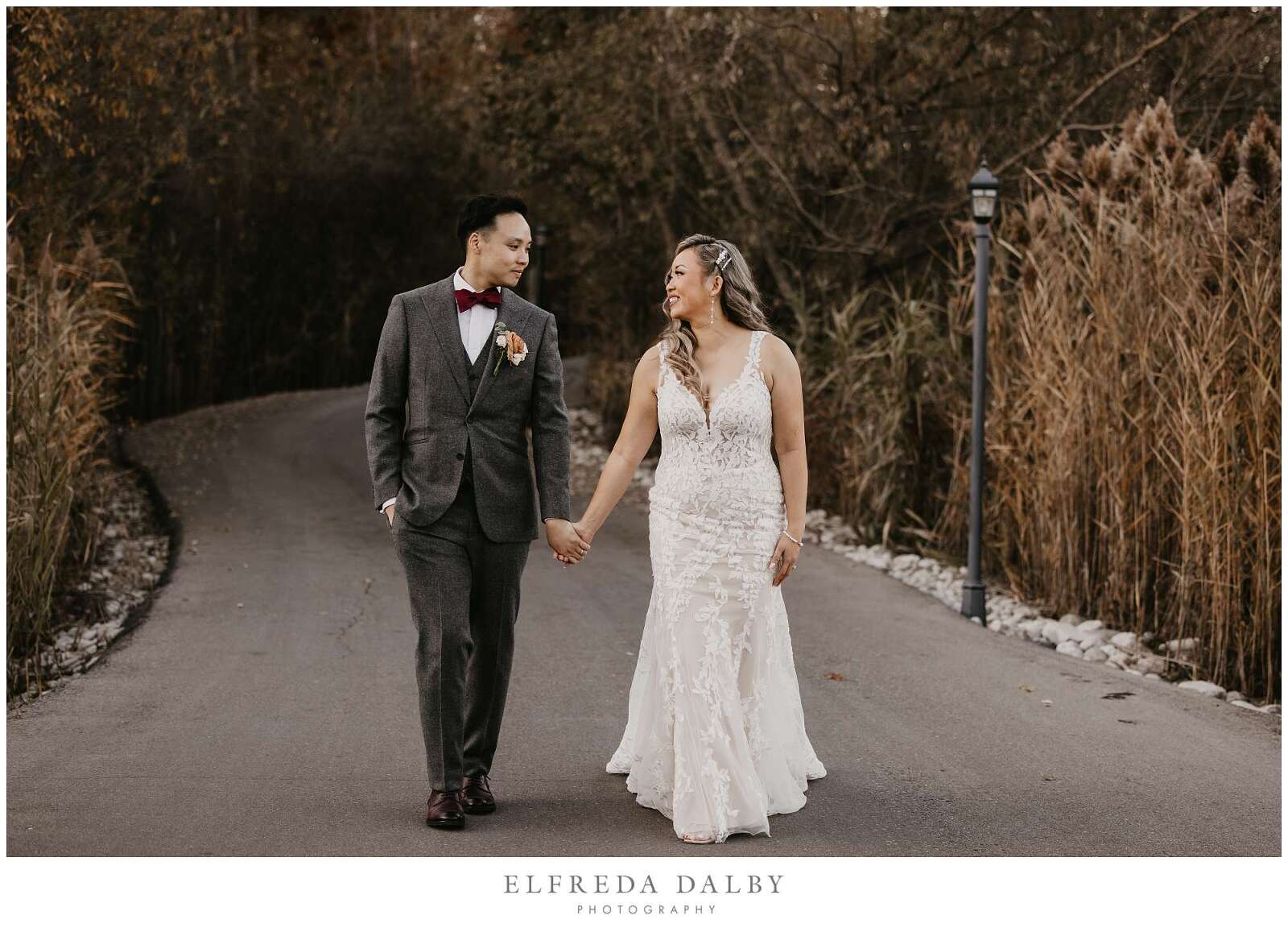 Bride and groom walking in the path at Whistle Bear Golf Club